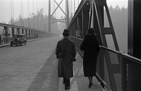 A man and woman walk across the still-relatively-new Lions Gate Bridge, 1939. City of Vancouver Archives. CVA 260-995. Photograph by James Crookall.