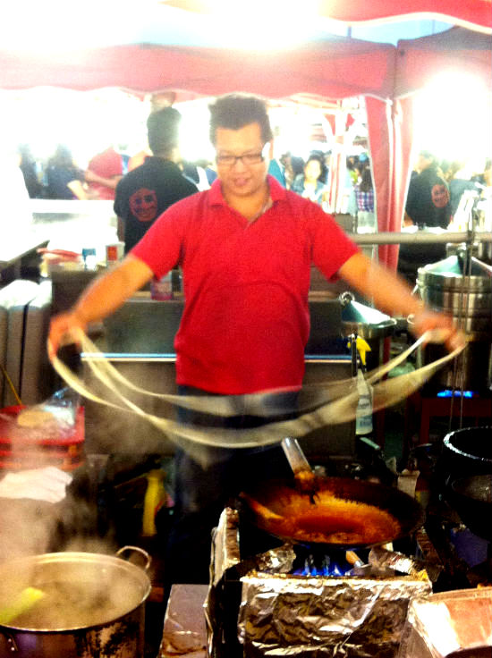 Hand-pulled noodles are part of the show. Carolyn Ali photo.