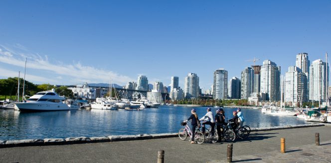 A group of cyclists on the False Creek Seawall in Vancouver.