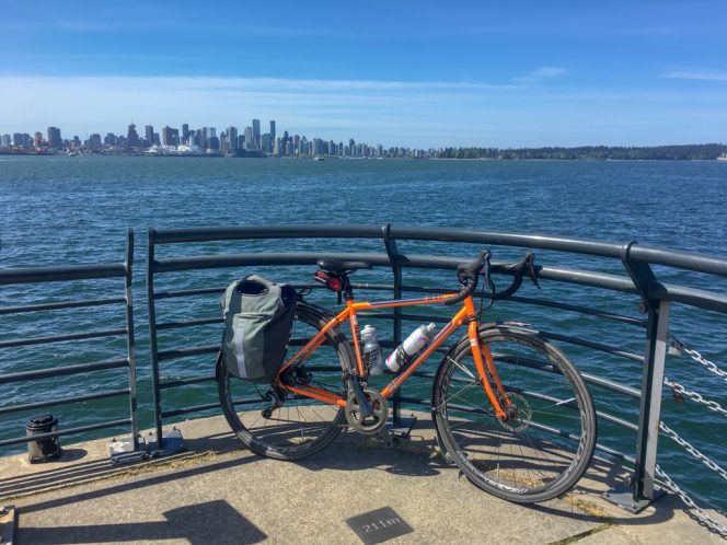 Bike on a pier at Lonsdale Quay with downtown Vancouver in the background.