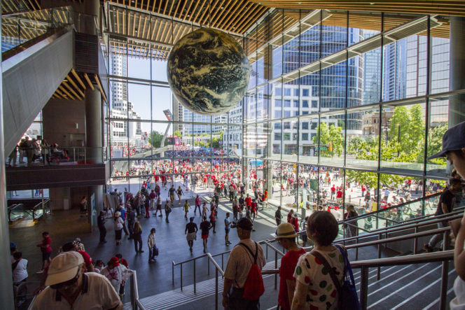 Entrance to Vancouver Convention Centre, glass walls, globe hanging from ceiliong. 