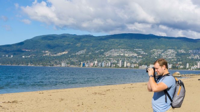 man taking photo Thurd beach Vancouver