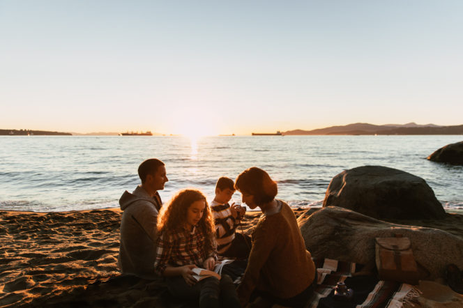 A group having a picnic at Third Beach in Stanley Park in Vancouver, BC