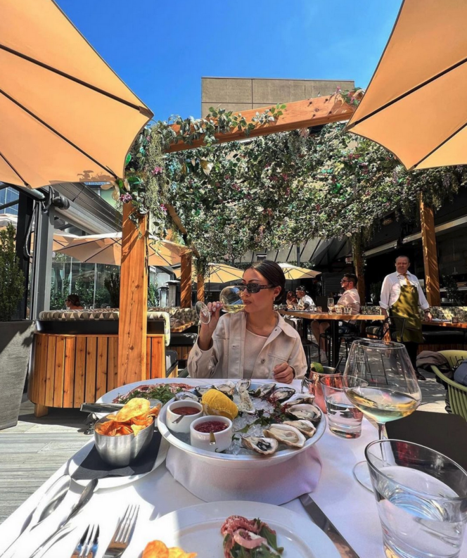 A woman enjoys seafood at The Roof at Black and Blue