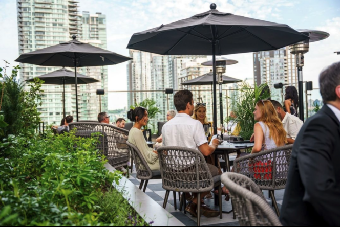 People enjoy the patio at Parker Rooftop in Vancouver