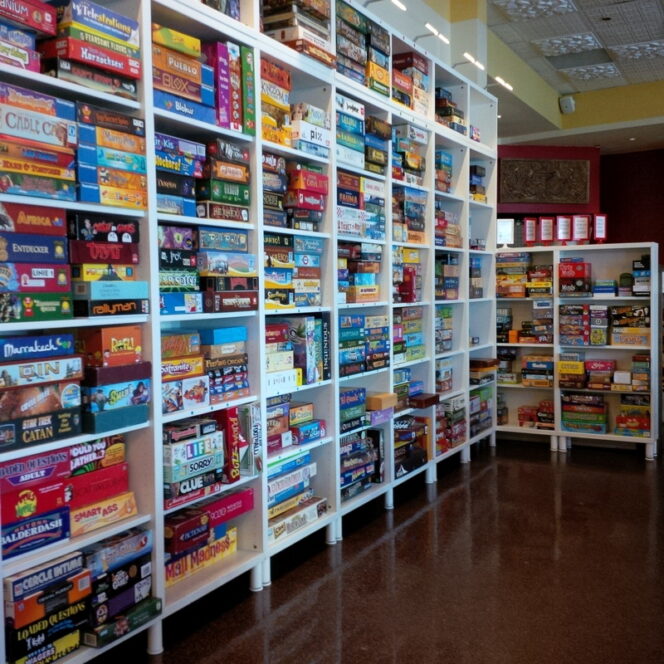 A shelf of board games at Pizzeria Ludica in Vancouver