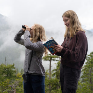 Two people bird watching at the Sea to Sky Gondola near Vancouver