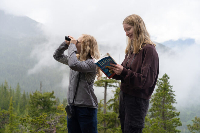 Two people bird watching at the Sea to Sky Gondola near Vancouver