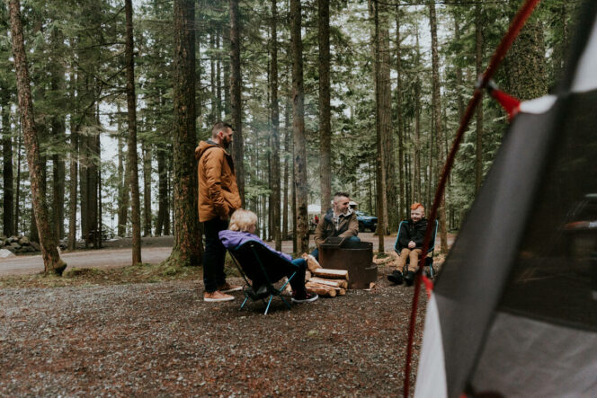 A family sits around a campfire at Chilliwack Lake Provincial Park near Vancouver