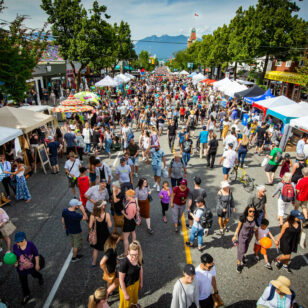 People and tents on the street at Main Street Car-Free Day in Vancouver.