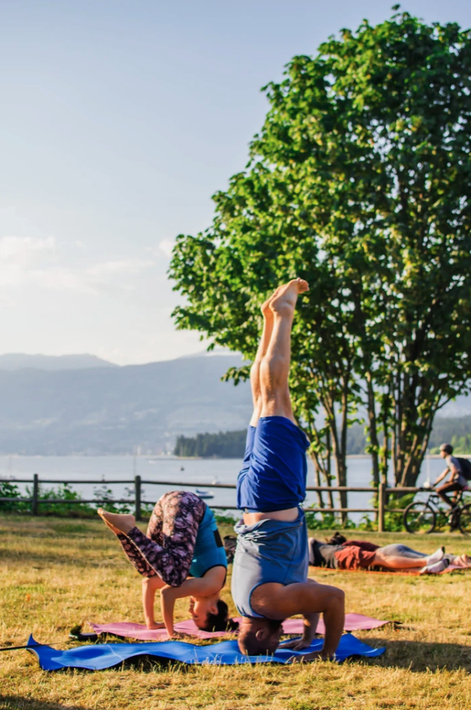 People participate in an outdoor yoga class with Mat Collective in Vancouver's Kitsilano neighbourhood. 