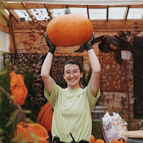 A woman holds a pumpkin at Art's Nursery in Surrey.