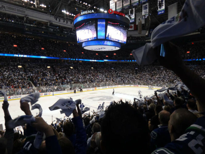 Cheering crowd at a Vancouver Canucks game. 