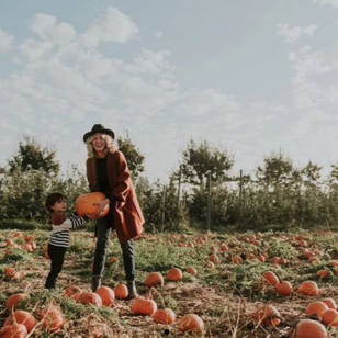 A woman holds a pumpkin in the Taves Family Farm pumpkin patch near Vancouver.